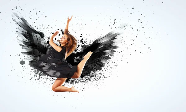 Woman floating on dark wings — Stock Photo, Image