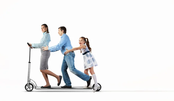 Happy family riding on scooter — Stock Photo, Image