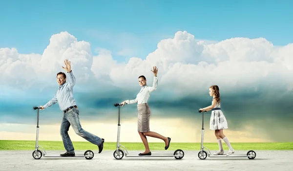 Happy family riding on scooter — Stock Photo, Image