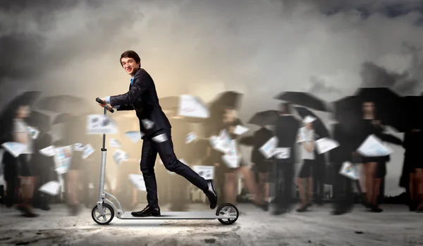 Businessman riding scooter — Stock Photo, Image