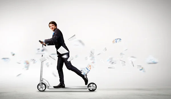 Businessman riding scooter — Stock Photo, Image