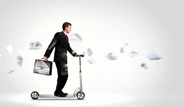 Businessman riding scooter — Stock Photo, Image