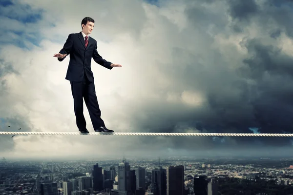 Businessman balancing on rope — Stock Photo, Image