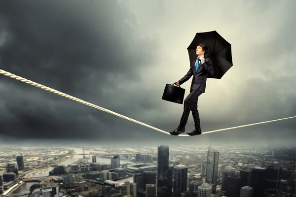 Businessman balancing on rope — Stock Photo, Image