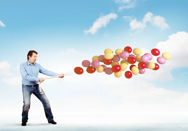 Man with bunch of balloons — Stock Photo, Image