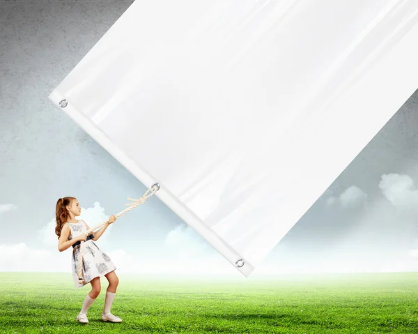 Little girl pulling banner — Stock Photo, Image