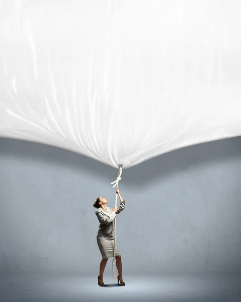 Businesswoman pulling banner — Stock Photo, Image