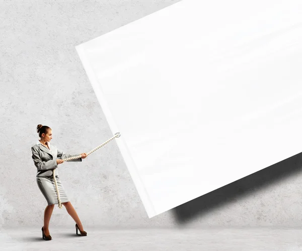 Businesswoman pulling banner — Stock Photo, Image