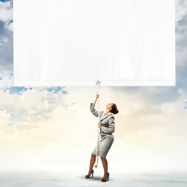 Businesswoman pulling banner — Stock Photo, Image