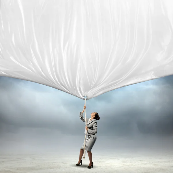 Businesswoman pulling banner — Stock Photo, Image