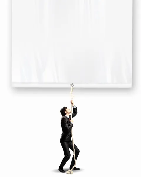 Businessman pulling banner — Stock Photo, Image