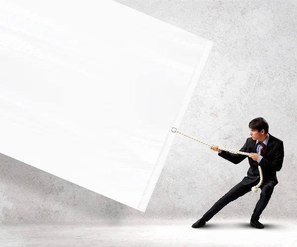 Businessman pulling banner — Stock Photo, Image