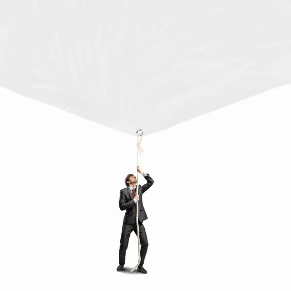 Businessman pulling banner — Stock Photo, Image