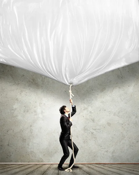 Businessman pulling banner — Stock Photo, Image