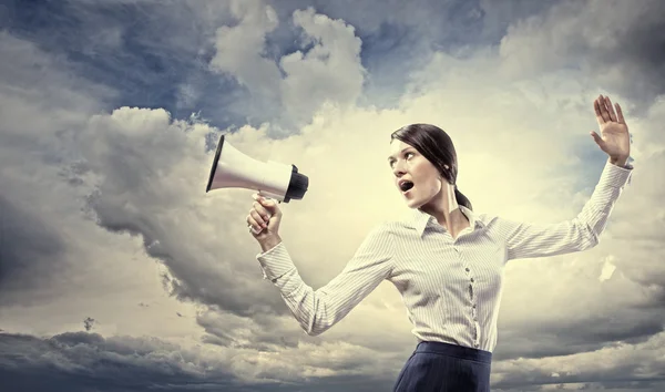 Businesswoman screaming in megaphone — Stock Photo, Image