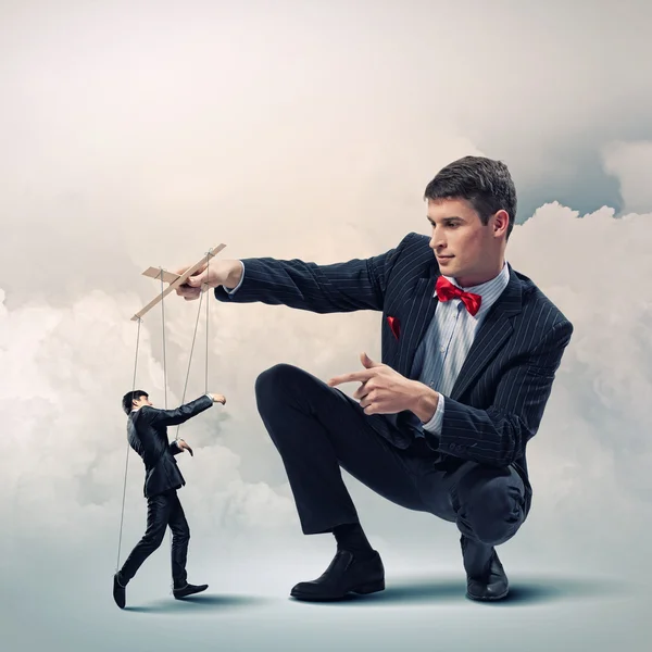 Businessman puppeteer — Stock Photo, Image