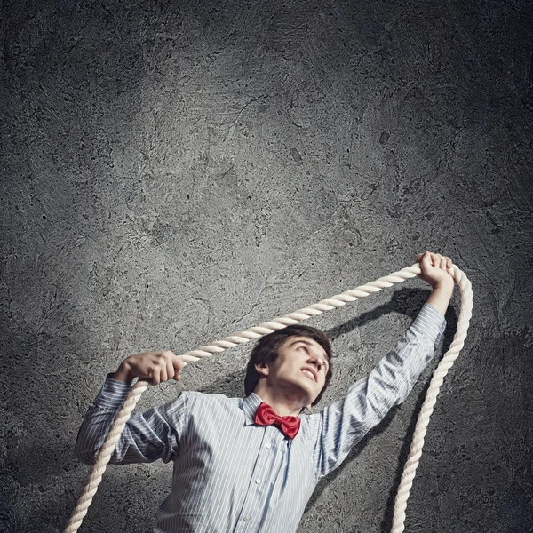 Businessman holding rope — Stock Photo, Image