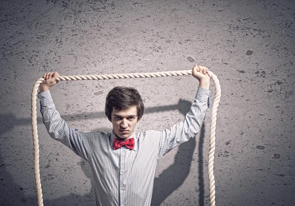 Businessman holding rope — Stock Photo, Image
