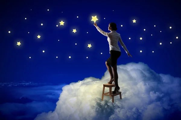 Woman lighting stars — Stock Photo, Image