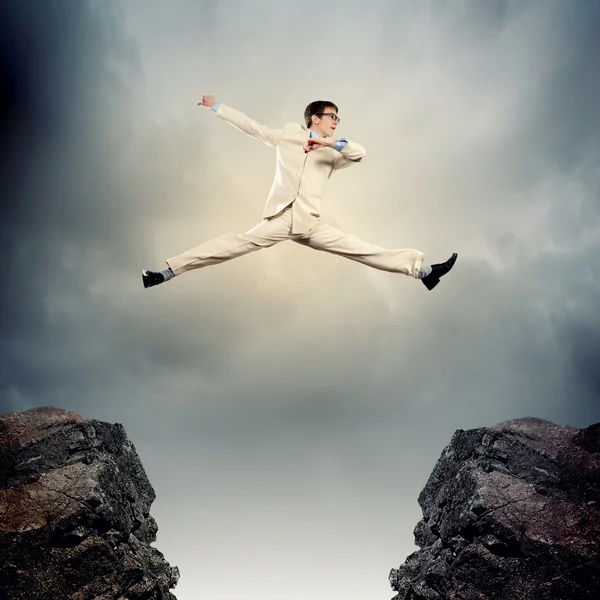 Businessman jumping over gap — Stock Photo, Image