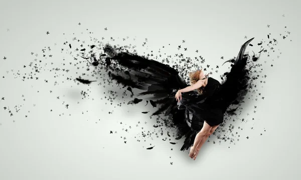 Woman floating on dark wings — Stock Photo, Image