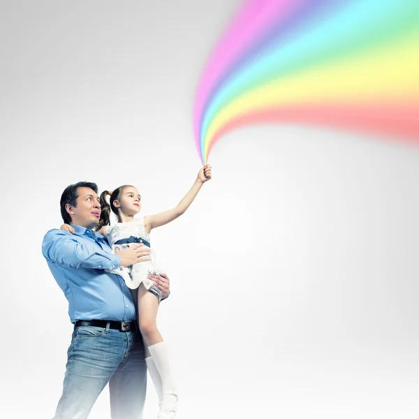 Father holding his daughter and rainbow — Stock Photo, Image