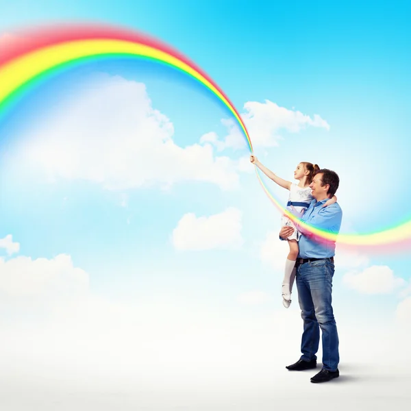 Father holding his daughter and rainbow — Stock Photo, Image