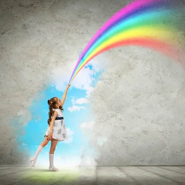 Liten flicka ritning rainbow — Stockfoto