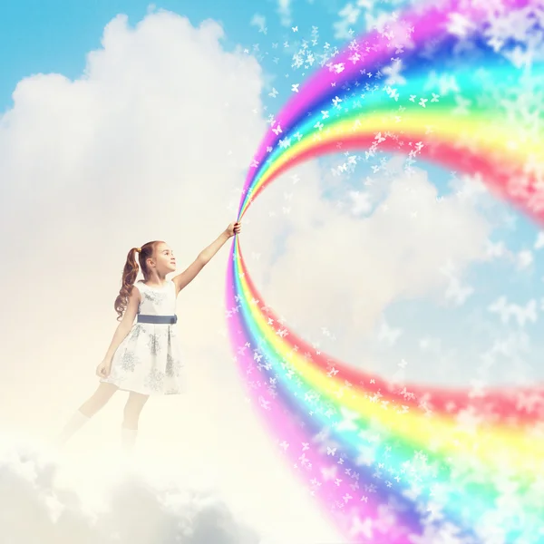Little girl drawing rainbow — Stock Photo, Image