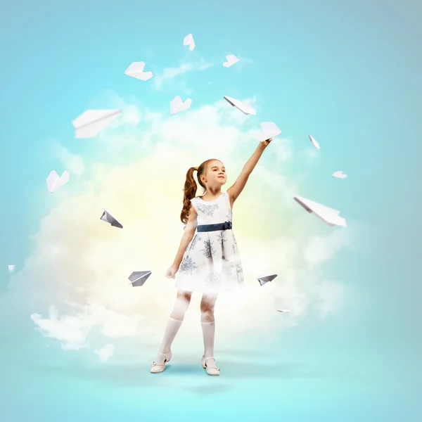 Little girl playing with paper airplane — Stock Photo, Image