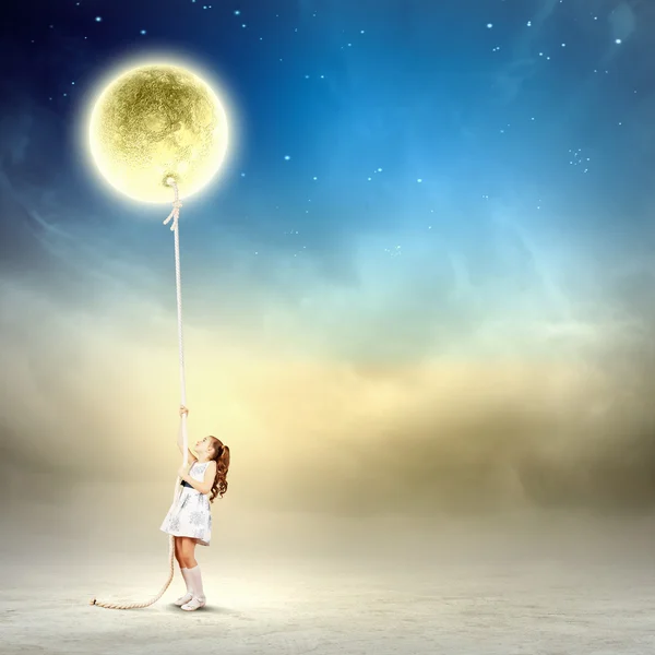 Little girl pulling moon — Stock Photo, Image