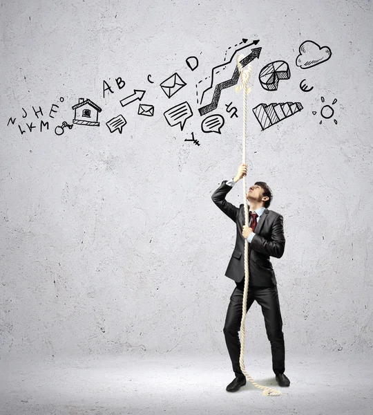 Handsome businessman pulling rope — Stock Photo, Image