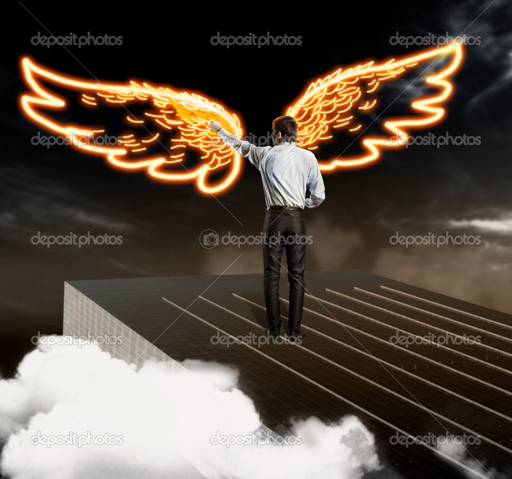 Businessman drawing wings