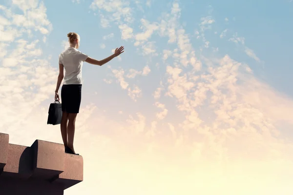 Businesswoman on top of building — Stock Photo, Image