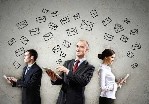 Three businesspeople with tablet pc in hands — Stock Photo, Image