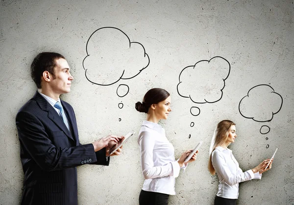 Three businesspeople with tablet pc in hands — Stock Photo, Image