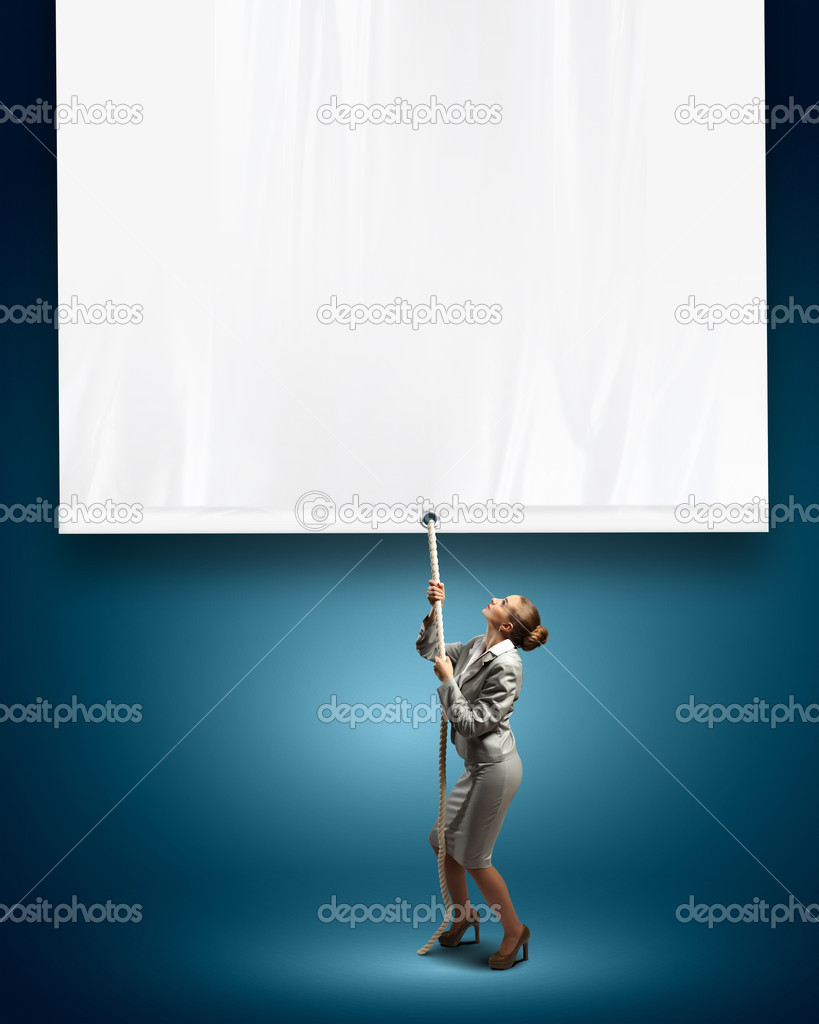 Businesswoman pulling blank banner