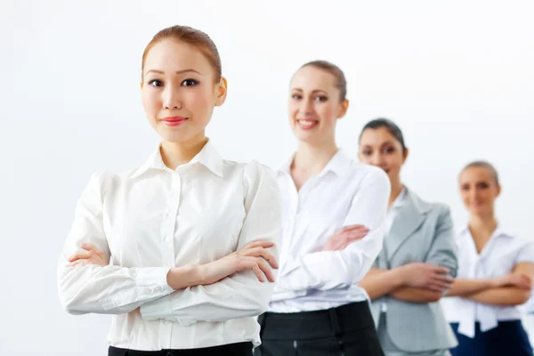 Four businesswomen standing in row — Stock Photo, Image