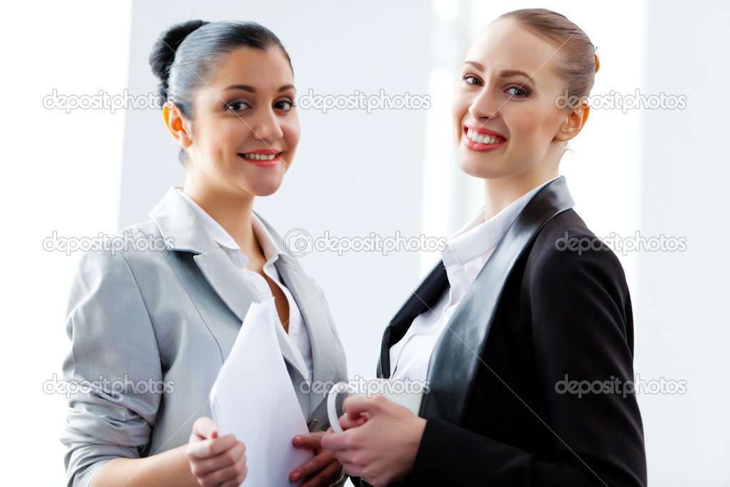 Two attractive business women smiling