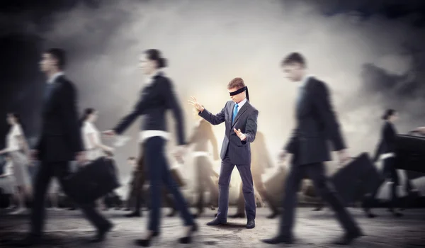 Businessman in blindfold among group of — Stock Photo, Image