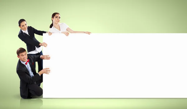 Three young holding banner — Stock Photo, Image