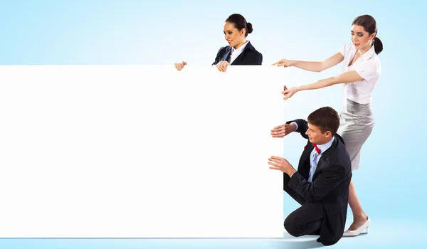 Three young holding banner — Stock Photo, Image