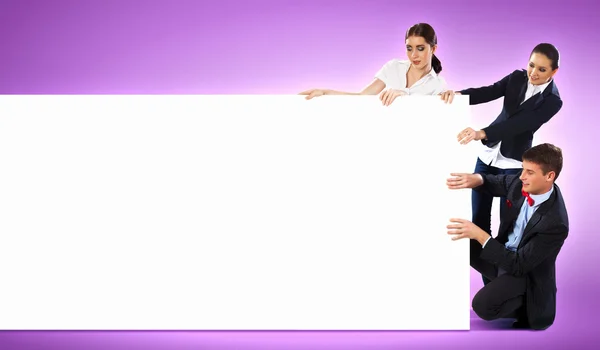 Three young holding banner — Stock Photo, Image