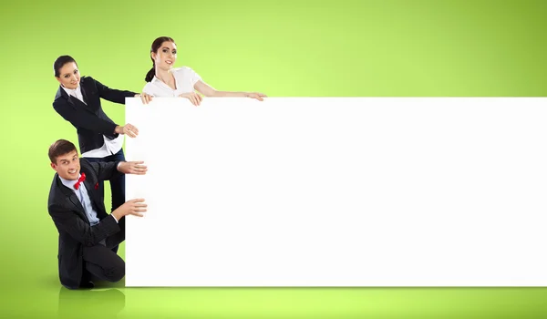 Three young holding banner — Stock Photo, Image