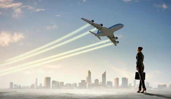 Donna d'affari guardando aeroplano in cielo — Foto Stock