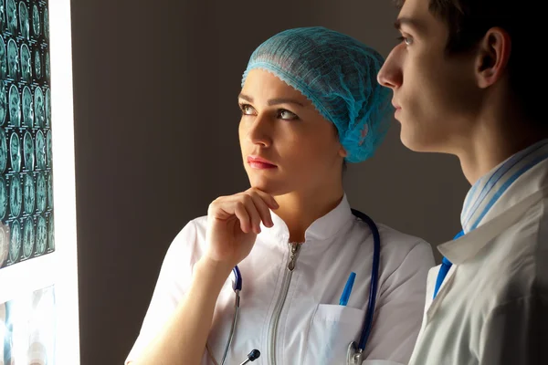 Two doctors examining x-ray results — Stock Photo, Image