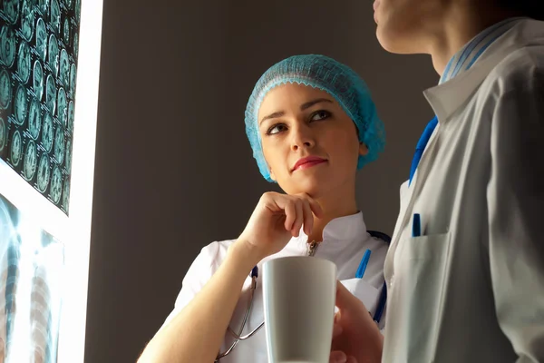 Two doctors examining x-ray results — Stock Photo, Image