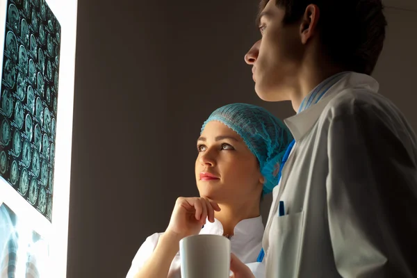 Two doctors examining x-ray results — Stock Photo, Image