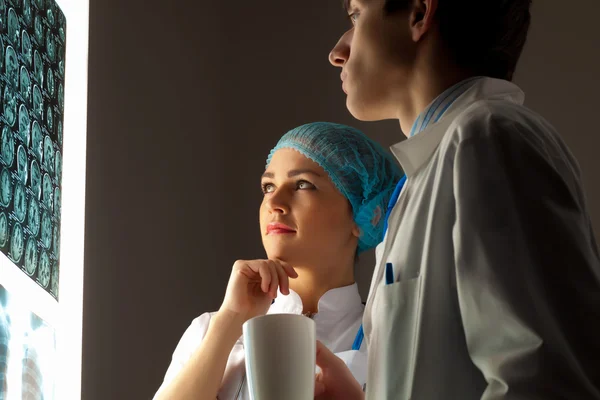 Two doctors examining x-ray results — Stock Photo, Image