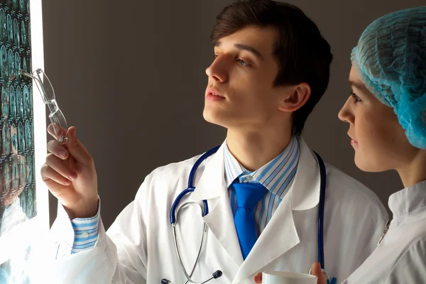 Two doctors examining x-ray results — Stock Photo, Image